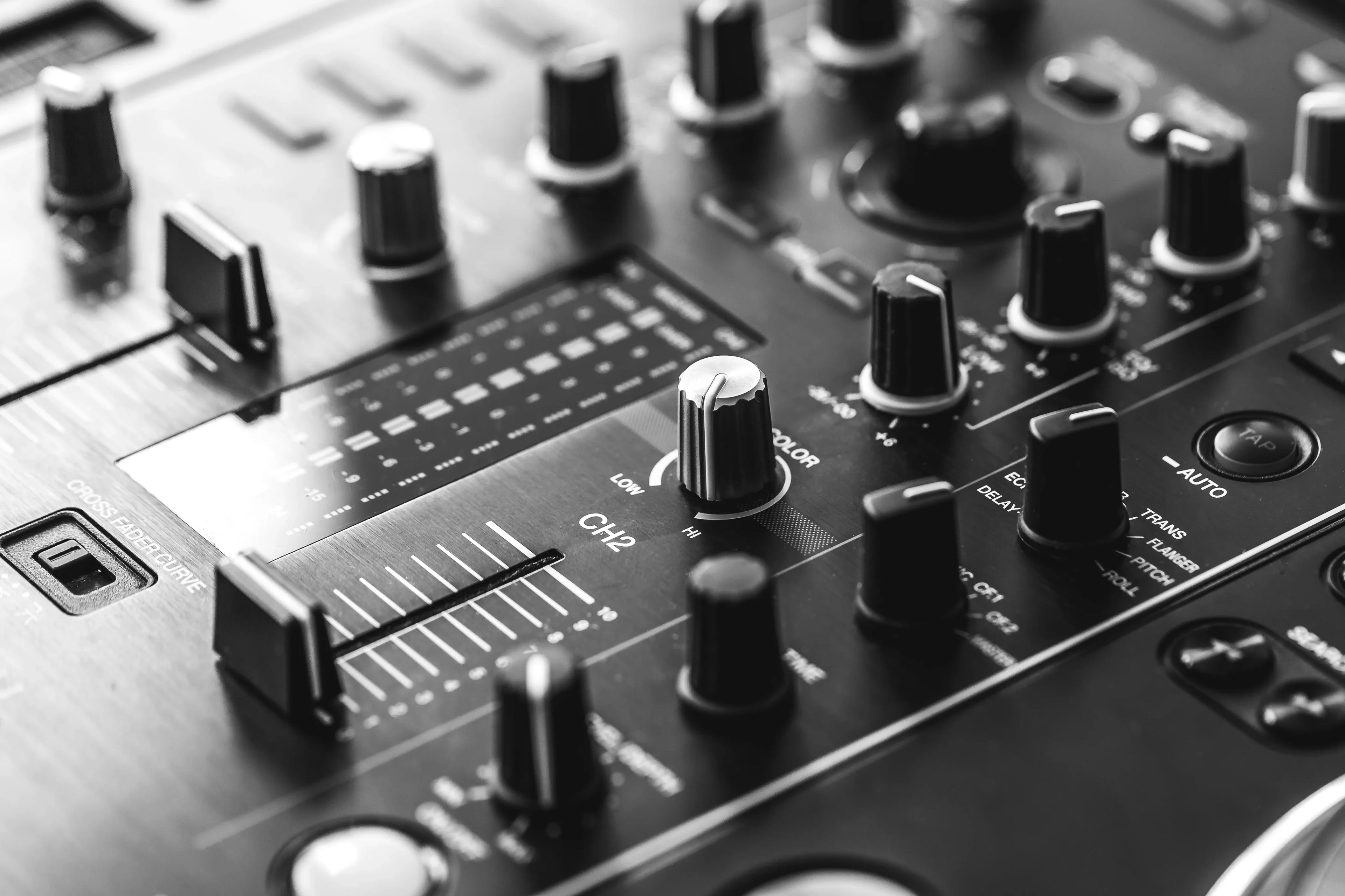 DJ mixer console with knobs and faders for event entertainment and music mixing