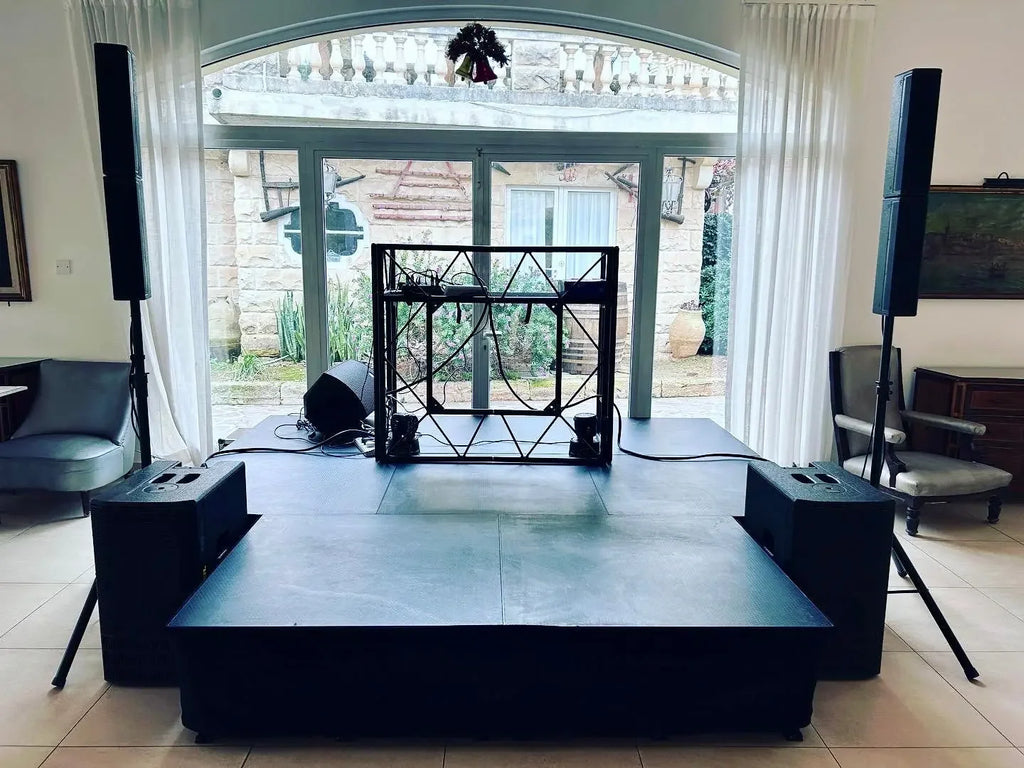 Professional DJ stage setup with speakers and lighting for weddings and events in Malta