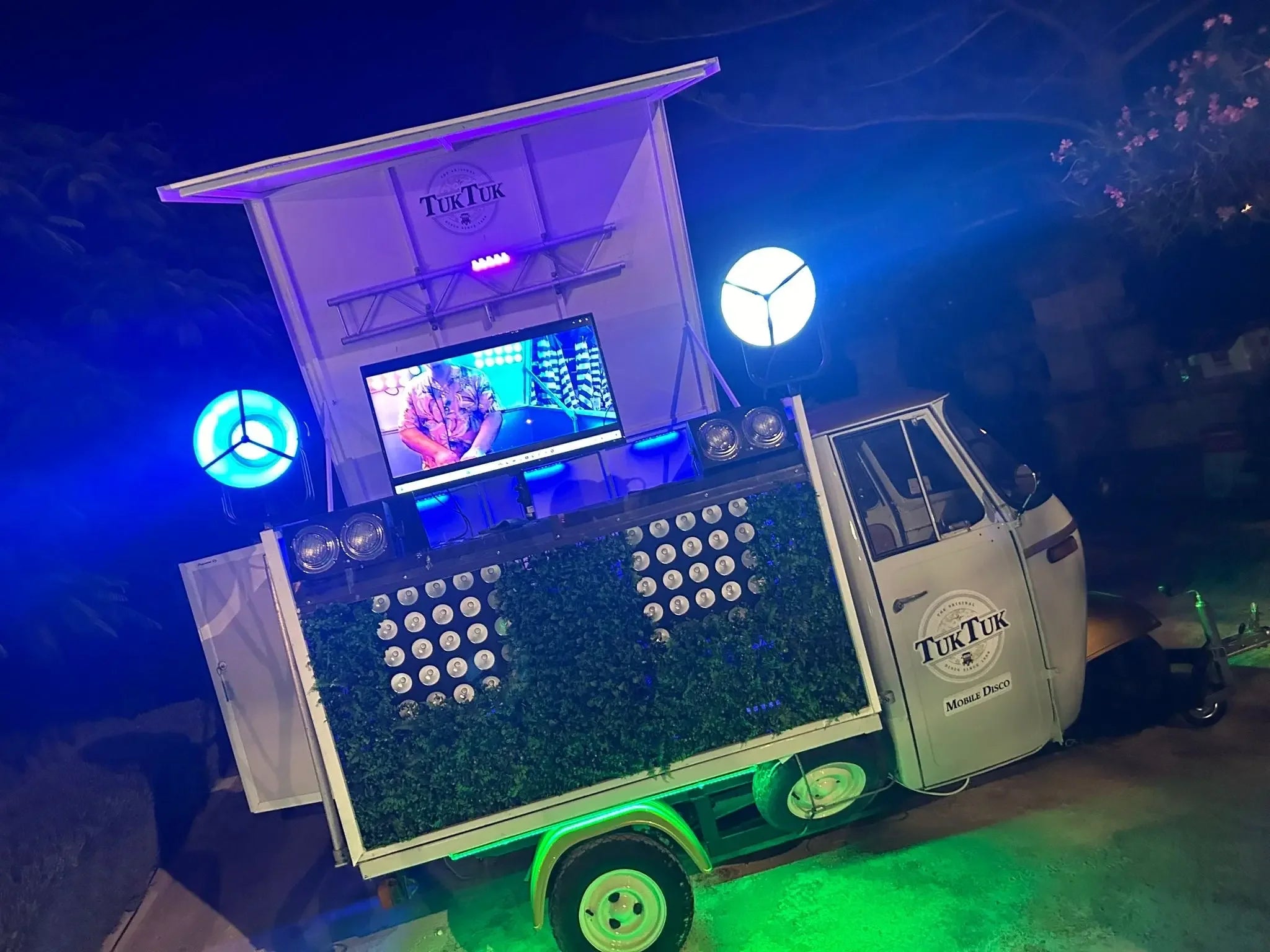TukTuk Mobile Disco with LED lights, screen, and greenery at night for events in Malta
