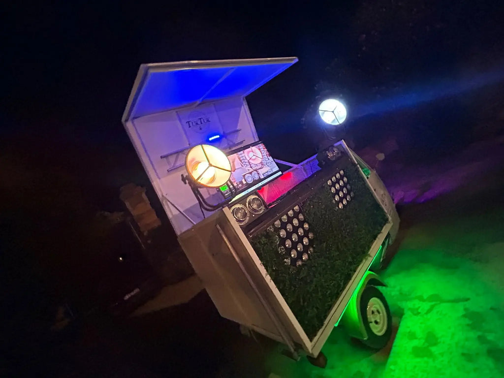 Mobile DJ setup with colorful lights and equipment for weddings and events at night